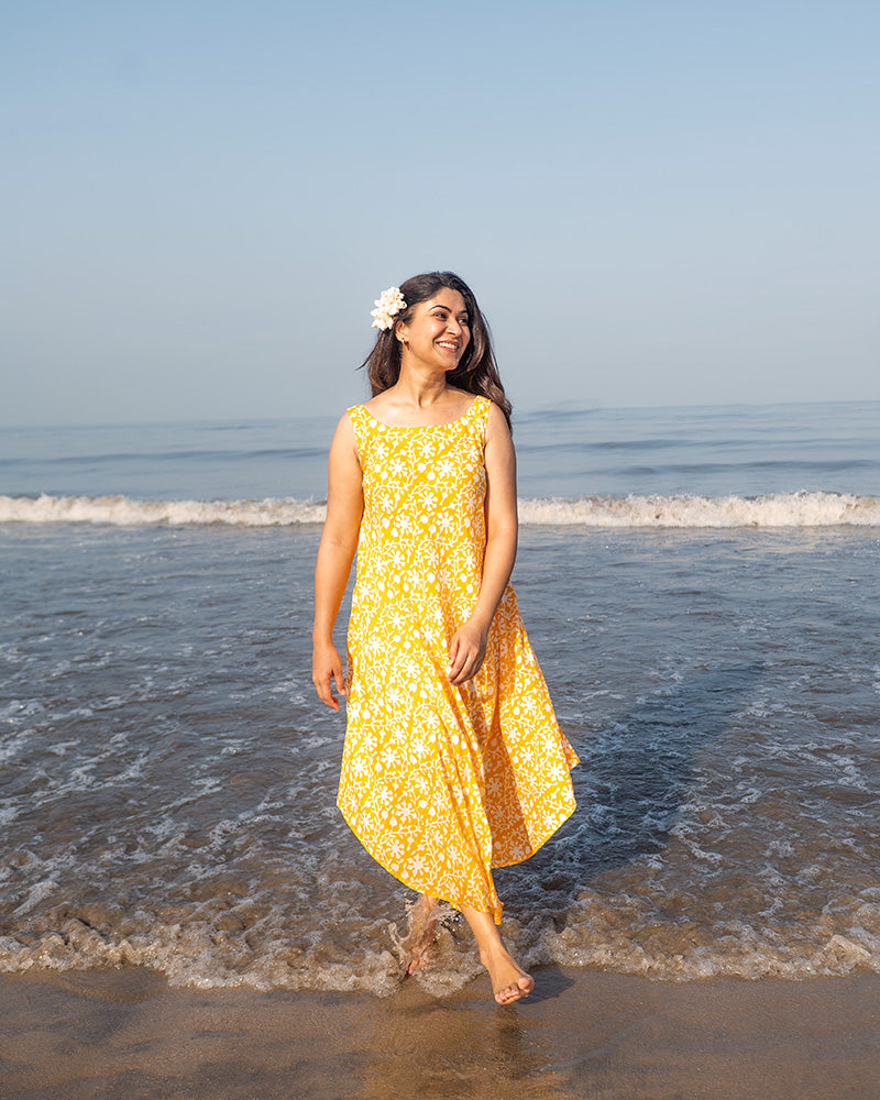A fuss free yellow floral hand block printed cotton sleeveless freesize high low summer dress in the softest and most airy style with pockets. 