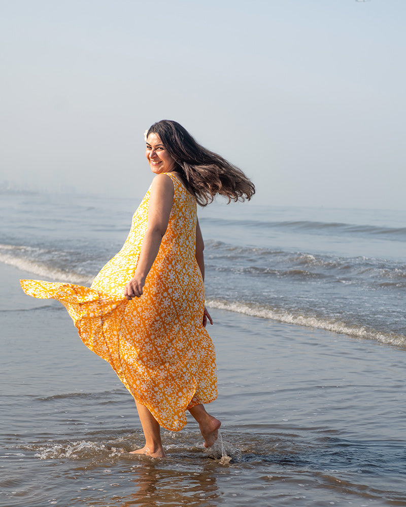 A fuss free yellow floral hand block printed cotton sleeveless freesize high low summer dress in the softest and most airy style with pockets. 