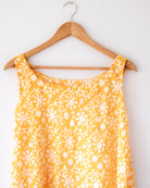 A fuss free yellow floral hand block printed cotton sleeveless freesize high low summer dress in the softest and most airy style with pockets. 