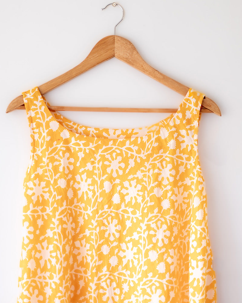 A fuss free yellow floral hand block printed cotton sleeveless freesize high low summer dress in the softest and most airy style with pockets. 