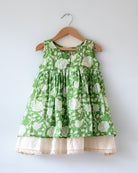 Sleeveless mul mul cotton layered pinafore style cute summer frock for girls in forest green and white colour. Vintage crochet detailing at the bottom of the dress. 
