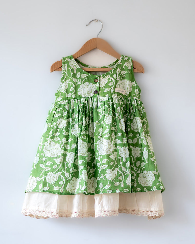 Sleeveless mul mul cotton layered pinafore style cute summer frock for girls in forest green and white colour. Vintage crochet detailing at the bottom of the dress. 