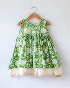 Sleeveless mul mul cotton layered pinafore style cute summer frock for girls in forest green and white colour. Vintage crochet detailing at the bottom of the dress. 