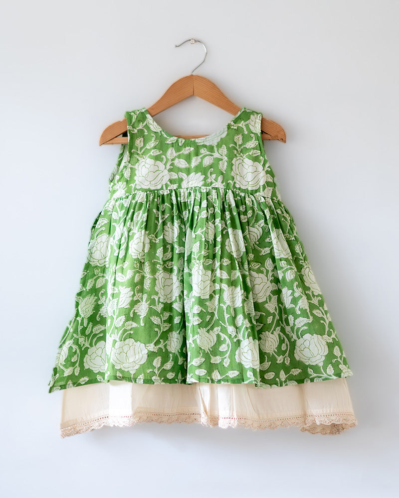 Sleeveless mul mul cotton layered pinafore style cute summer frock for girls in forest green and white colour. Vintage crochet detailing at the bottom of the dress. 
