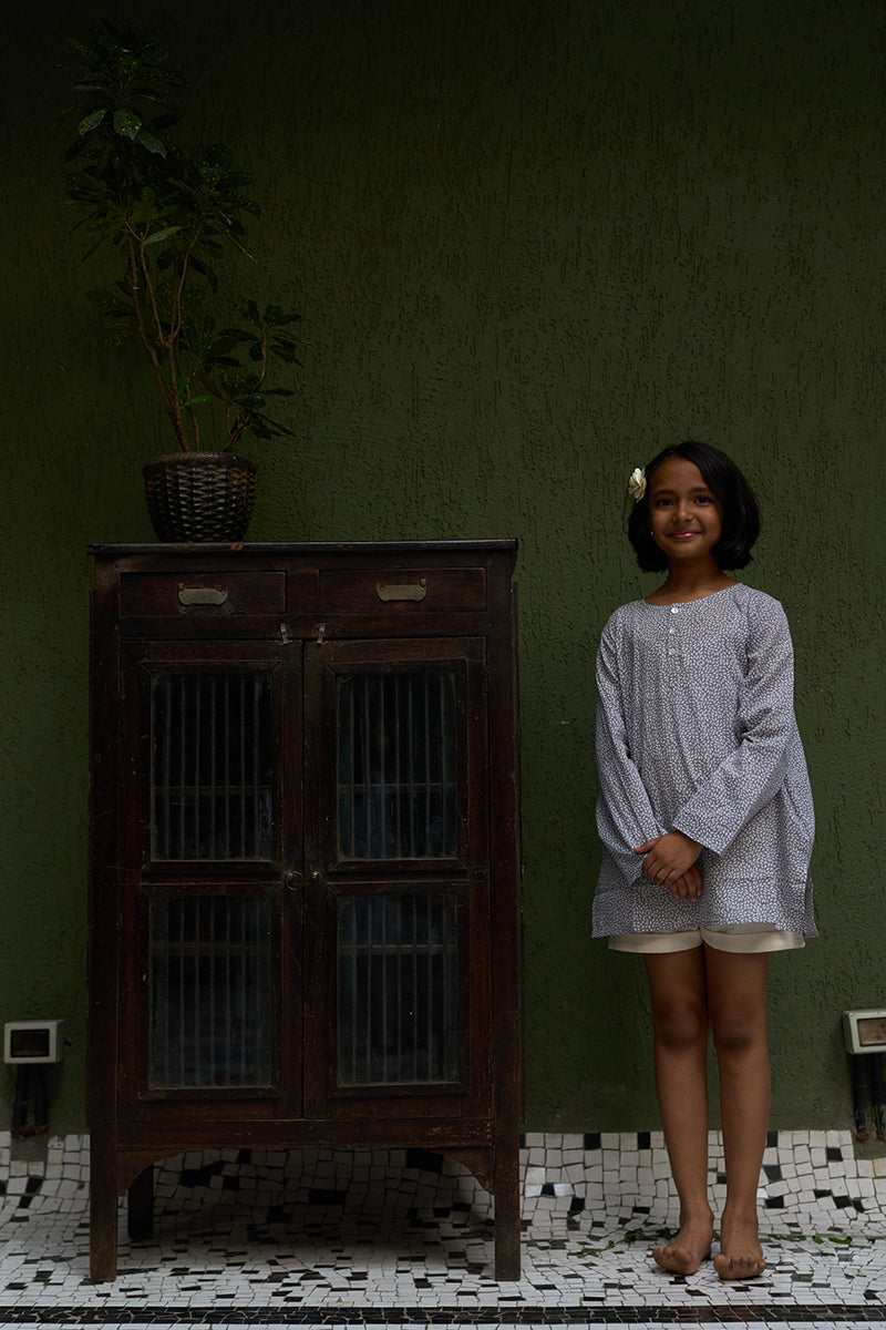 girl-dressed-in-unisex-kids-grey-kurta-for-boys-and-girls-handblock-printed-in-Jaipur-made-with-soft-and-breathable-cotton