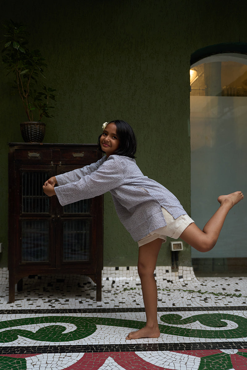 girl-dressed-in-unisex-kids-grey-kurta-for-boys-and-girls-handblock-printed-in-Jaipur-made-with-soft-and-breathable-cotton