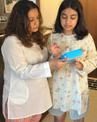 Unisex adults white cotton kurta and red shorts co ord set. 100% Cotton striped Shorts hand block printed by artisans in Jaipur, Rajasthan. Kurta made in GOTS certified organic cotton, has pockets and natural shell buttons.