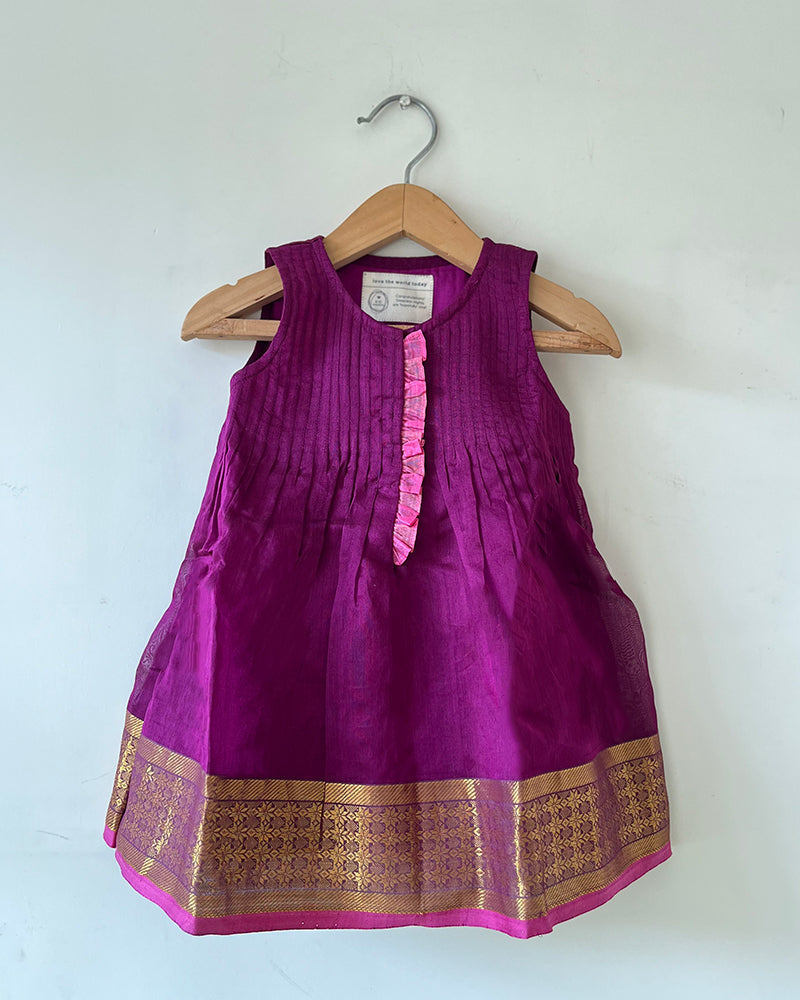 A deep purple violet sleeveless flared dress for infants in handwoven cotton silk by artisans in Maheshwar Madhya Pradesh. Perfect for festivities like Navratri, diwali, Dussehra, dushehra, bhai dooj. Infant wear. Baby ethnic wear. Silkwear for babies. Baby girl festive wear. 