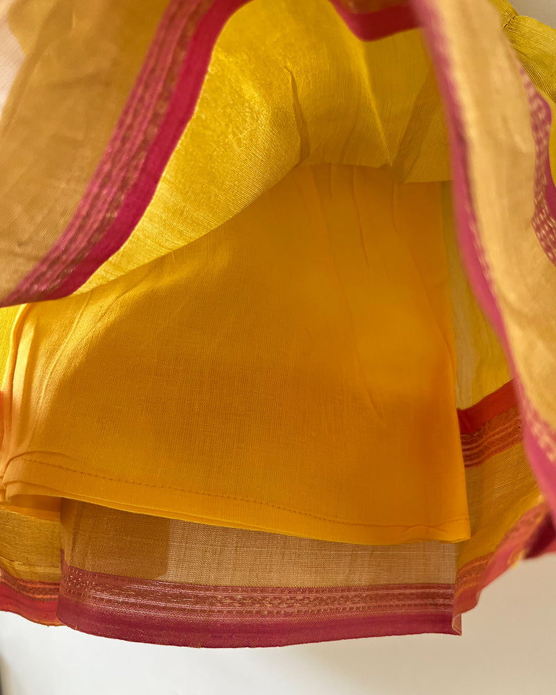 A bright yellow & pink sleeveless tiered dress for infants in handwoven cotton silk by artisans in Maheshwar Madhya Pradesh. Perfect for festivities like Navratri, diwali, Dussehra, dushehra, bhai dooj. Infant wear. Baby ethnic wear. Silkwear for babies. Baby girl festive wear.  Baby dress with lining. 