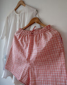 Unisex adults GOTS certified organic cotton white kurta and cotton peach shorts co ord set. 100% Cotton checkered Shorts hand block printed by artisans in Jaipur, Rajasthan. Kurta has pockets printed by hand block print. Shorts have soft elastication and drawstring at waist for ease of wear.