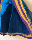 A deep teal blue sleeveless tiered dress with golden checks for infants in handwoven cotton silk by artisans in Maheshwar Madhya Pradesh. Perfect for festivities like Navratri, diwali, Dussehra, dushehra, bhai dooj. Infant wear. Baby ethnic wear. Silkwear for babies. Baby girl festive wear. Baby dress with lining. 