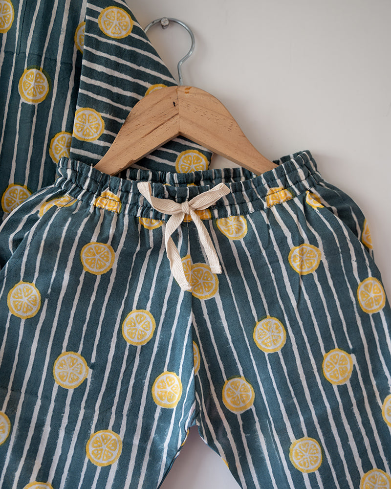 Unisex cotton striped shirt and pajama hand block printed with pockets and natural shell buttons. Pajama has elastication & drawstring at waist for ease of wear. Kimono style shirt & pajama set.