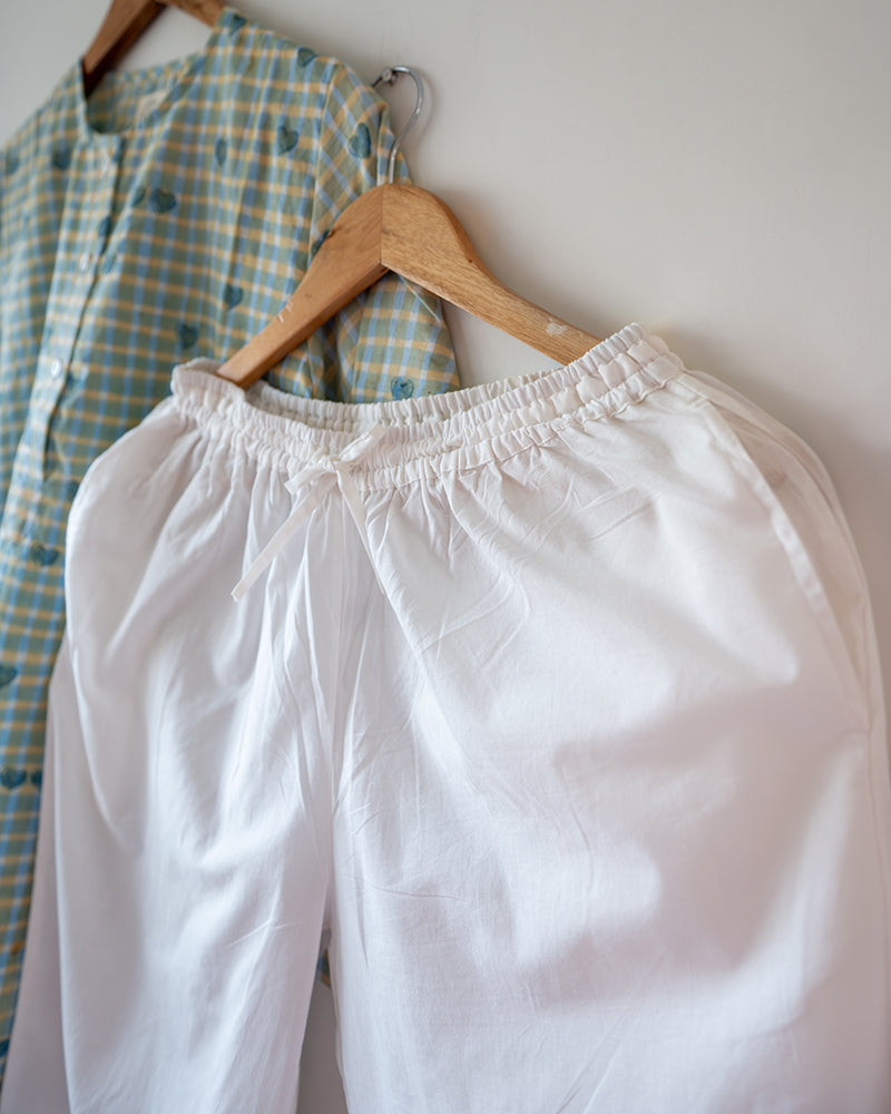 Unisex GOTS certified organic cotton pajama paired with blue checkered hand block printed kurta with pockets and natural shell buttons. Pajama has elastication at waist for ease of wear. Grandpa style kurta pajama set.