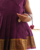 A girl wearing a cute deep purple violet cotton silk sharara suit set handwoven with golden border by weavers in Maheshwar, Madhya Pradesh.