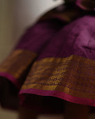 A girl wearing a cute deep purple violet cotton silk sharara suit set handwoven with golden border by weavers in Maheshwar, Madhya Pradesh. Kids ethnic outfits, traditional clothing for kids. Silkwear for kids. Sharara set, suit set, salwar set for girls. 