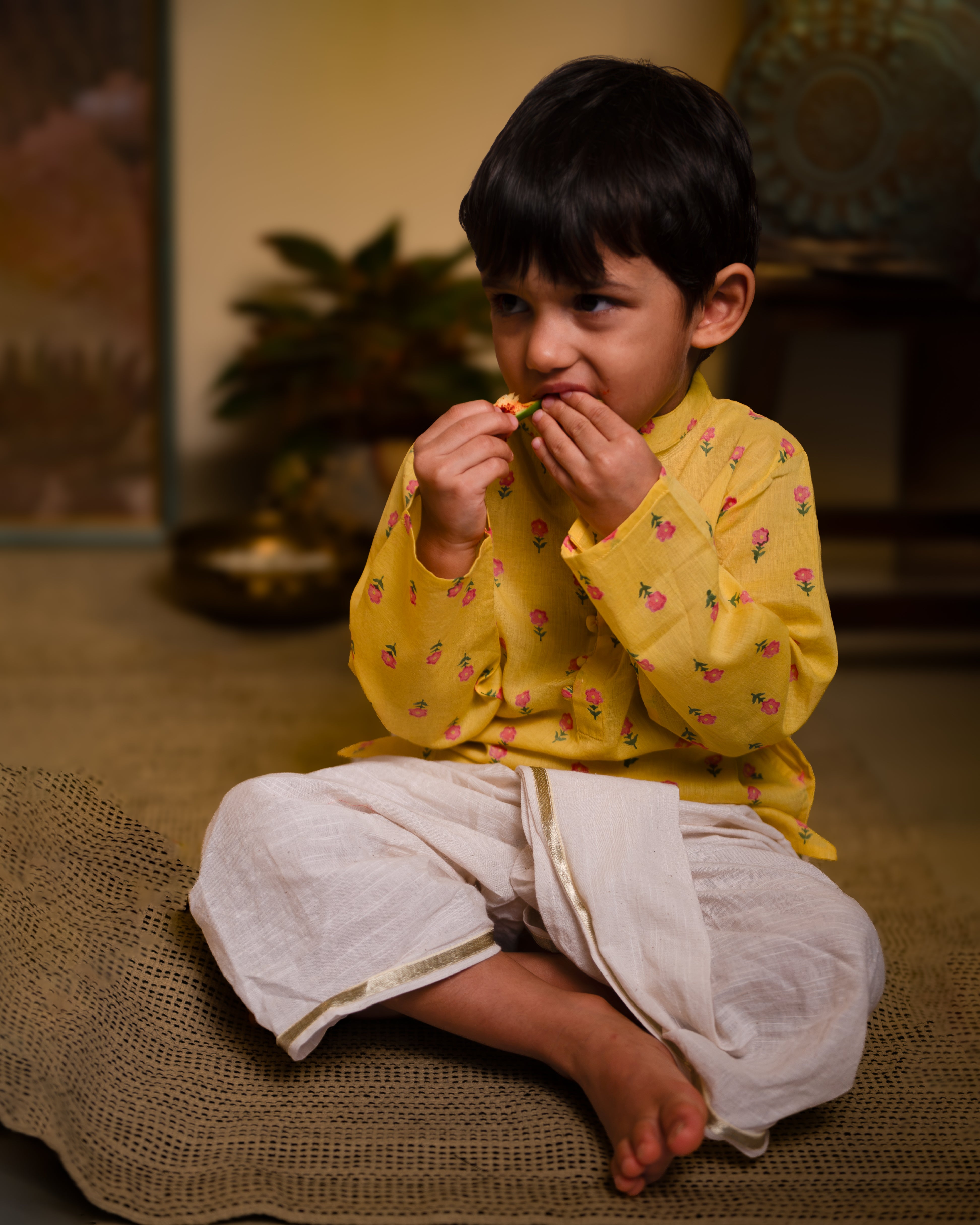 Bright festive yellow kurta with potli buttons. Beautiful floral motifs hand block printed on pure cotton. Paired with a pure cotton handwoven dhoti with gota selvedge.