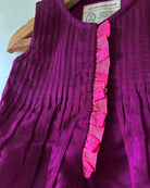 A deep purple violet sleeveless flared dress for infants in handwoven cotton silk by artisans in Maheshwar Madhya Pradesh. Perfect for festivities like Navratri, diwali, Dussehra, dushehra, bhai dooj. Infant wear. Baby ethnic wear. Silkwear for babies. Baby girl festive wear. 