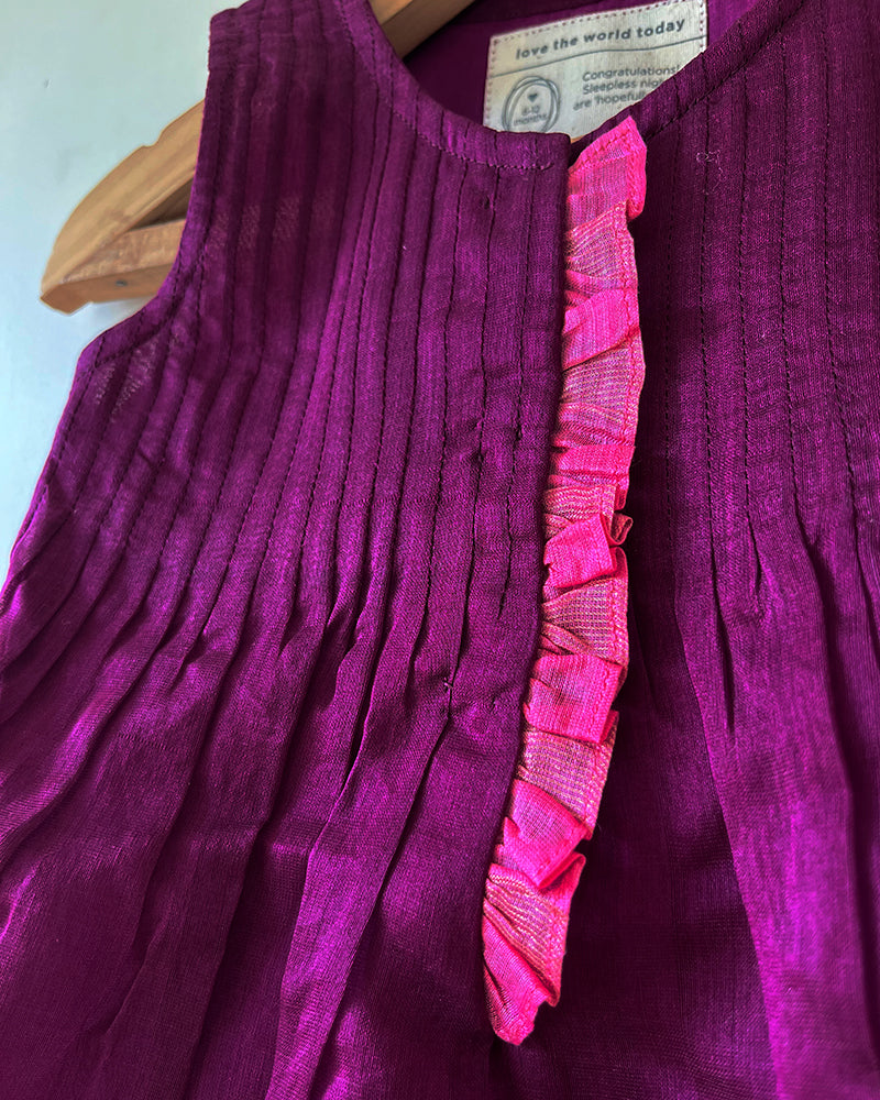 A deep purple violet sleeveless flared dress for infants in handwoven cotton silk by artisans in Maheshwar Madhya Pradesh. Perfect for festivities like Navratri, diwali, Dussehra, dushehra, bhai dooj. Infant wear. Baby ethnic wear. Silkwear for babies. Baby girl festive wear. 