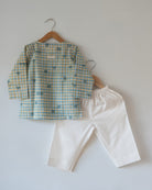 Unisex GOTS certified organic cotton pajama paired with blue checkered hand block printed kurta with pockets and natural shell buttons. Pajama has elastication at waist for ease of wear. Grandpa style kurta pajama set.