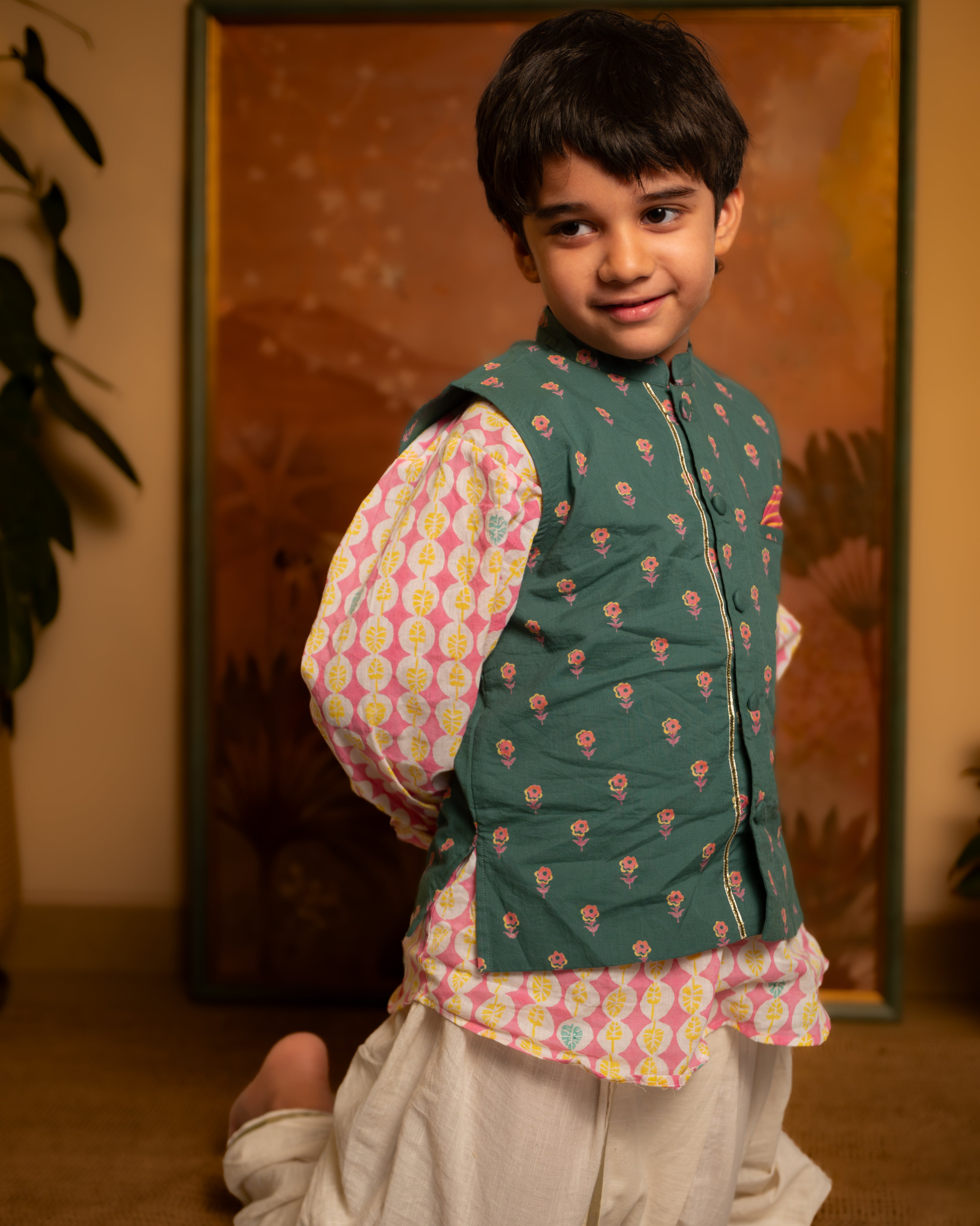 Dark green floral cotton bandi nehru jacket with self potli buttons and a golden selvedge.