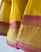 A bright yellow & pink sleeveless tiered dress for infants in handwoven cotton silk by artisans in Maheshwar Madhya Pradesh. Perfect for festivities like Navratri, diwali, Dussehra, dushehra, bhai dooj. Infant wear. Baby ethnic wear. Silkwear for babies. Baby girl festive wear.  border dress. 