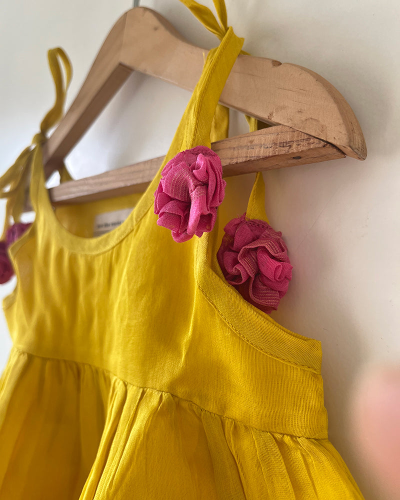 A bright yellow & pink sleeveless tiered dress for infants in handwoven cotton silk by artisans in Maheshwar Madhya Pradesh. Perfect for festivities like Navratri, diwali, Dussehra, dushehra, bhai dooj. Infant wear. Baby ethnic wear. Silkwear for babies. Baby girl festive wear.  Dress with tassels.