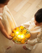 A Boy wearing an off white Indian festive Kurta with golden stripes made with Handwoven cotton silk fabric woven by artisans in Maheshwar Madhya Pradesh. Siblings duo. Brother sister celebrating diwali. Siblings celebration. Festival of lights. 