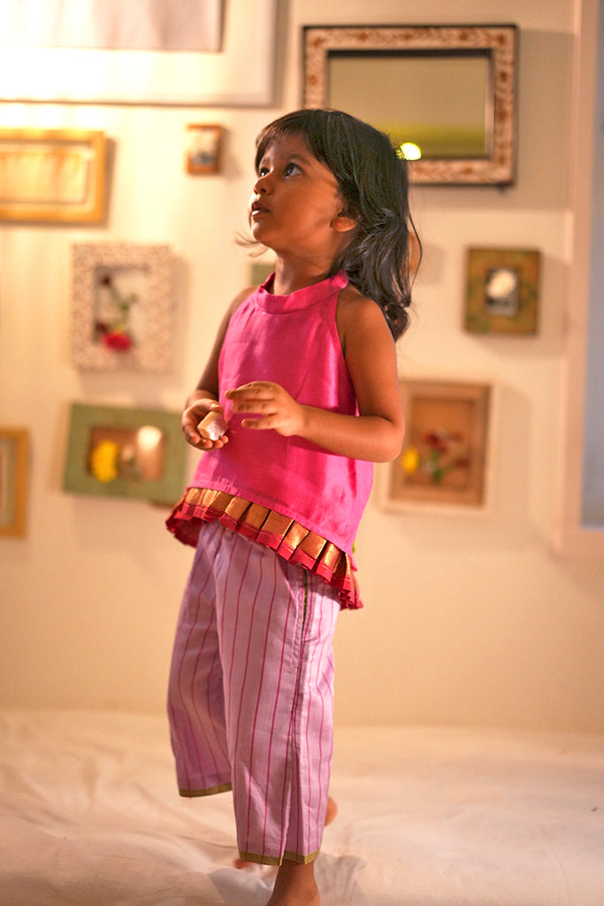 Little girl in a festive pink halter neck top and purple sharara pant