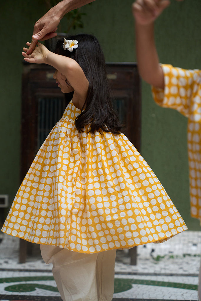 cute-little-girl-twirling-and-dancing-in-girls-kurta-coord-set-in-yellow-polka-hand-block-print-and-cotton-dhoti-pant