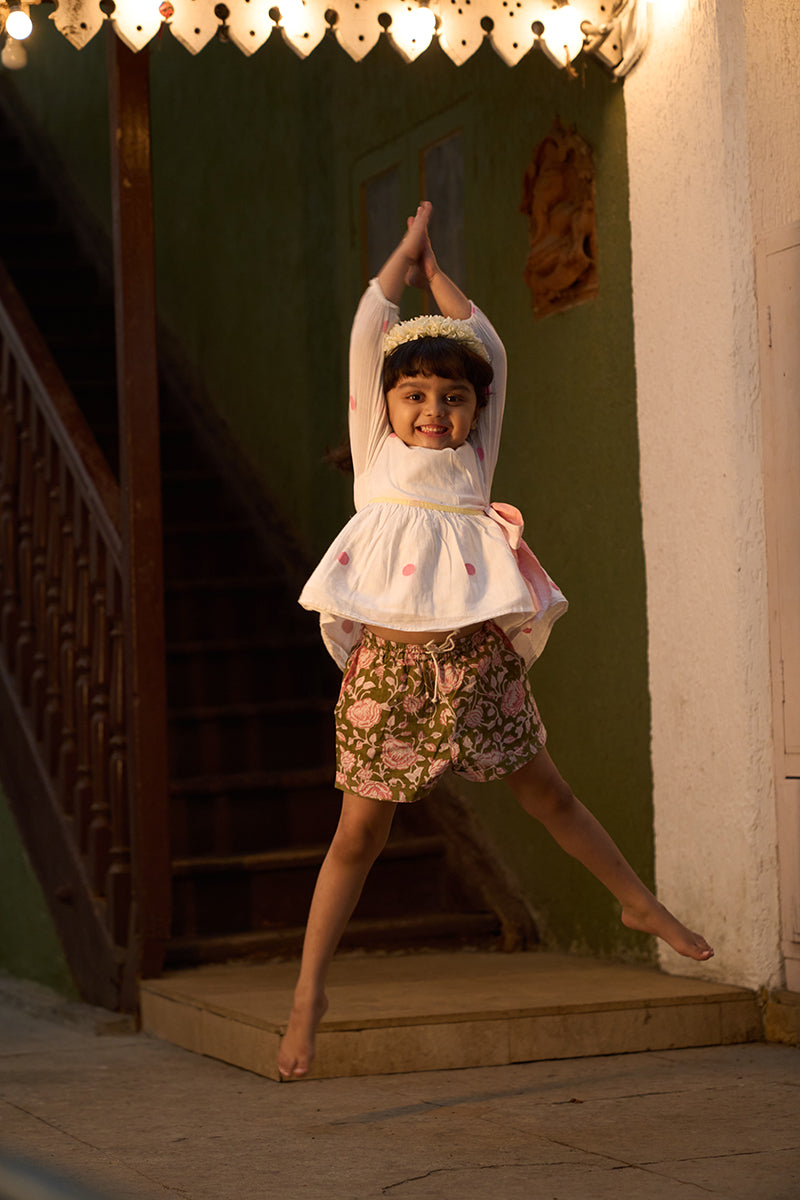 girl-dancing-in-lovetheworldtodays-unisex-green-floral-hand-block-print-cotton-shorts