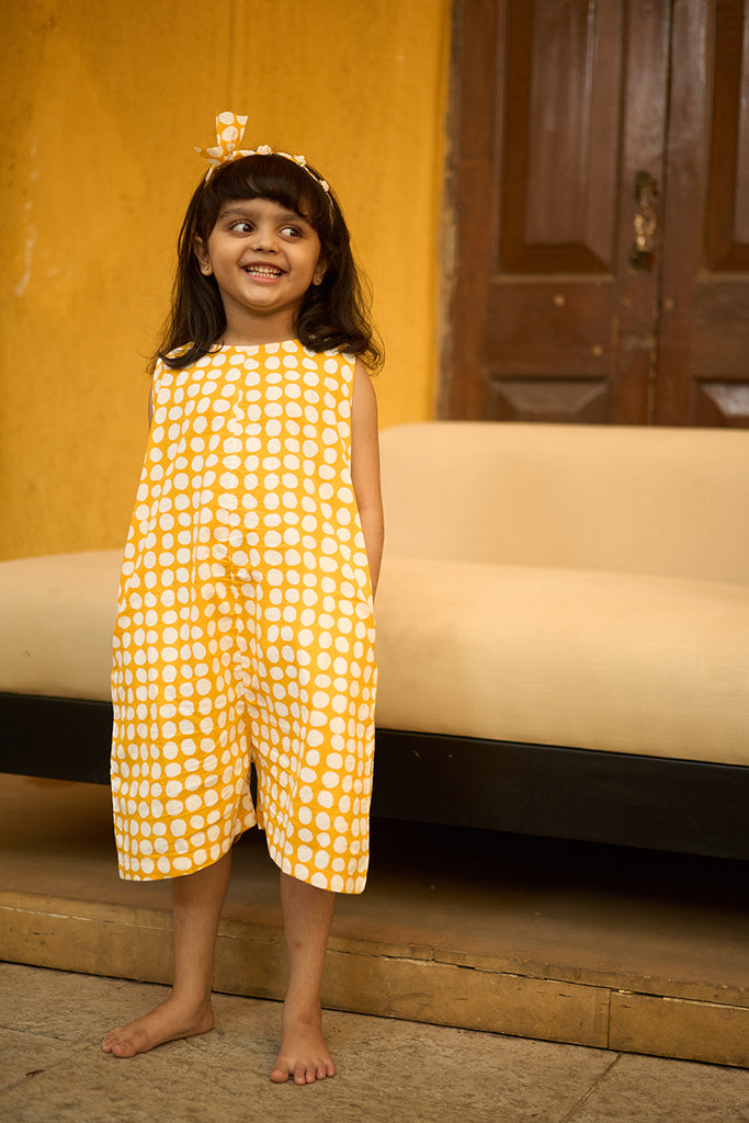 cute-little-girl-dressed-for-a-playdate-in-lovetheworldtodays-yellow-polka-unisex-romper-jumpsuit-made-with-handblock-print-cotton
