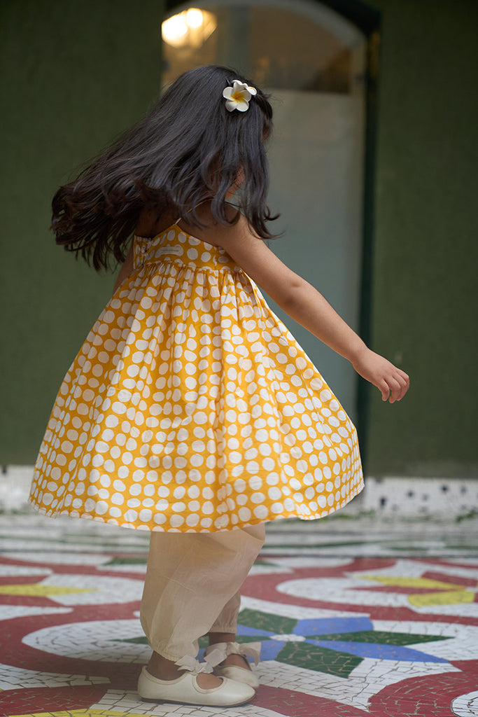 cute-little-girl-twirling-and-dancing-in-girls-kurta-coord-set-in-yellow-polka-hand-block-print-and-cotton-dhoti-pant