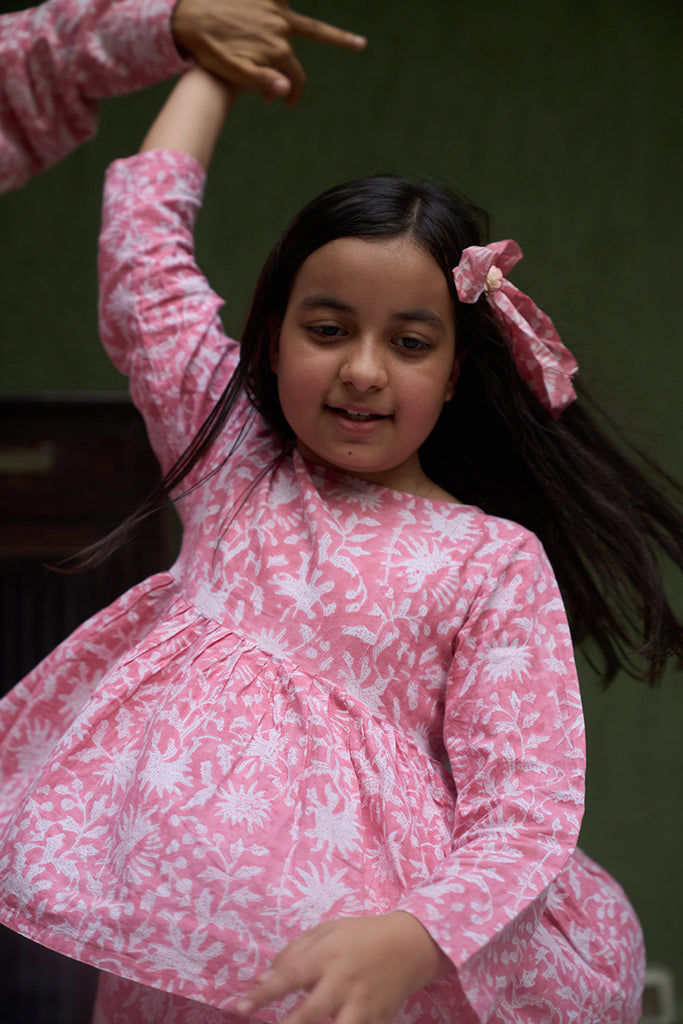 little-girl-twirling-and-dancing-in-a-pink-floral-fullsleeve-coord-set-handblock-printed-in-Jaipur