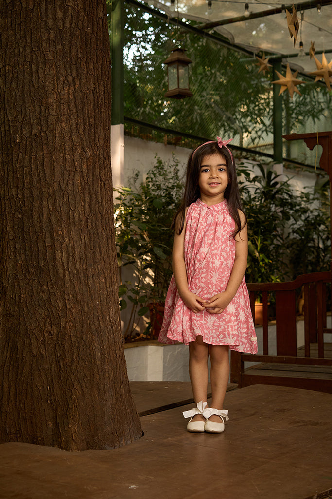 pretty-girl-in-halter-neck-summer-dress-in-pink-floral-handblock-print-with-buttons-at-the-back
