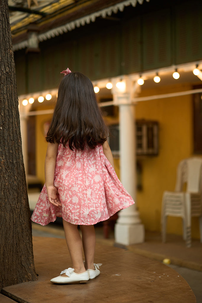 pretty-girl-in-halter-neck-summer-dress-in-pink-floral-handblock-print-with-buttons-at-the-back