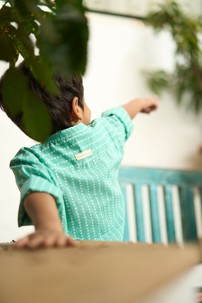 Little-boy-in-Lovetheworldtoday's-classic-Barefoot-Boy-mandarin-collar-hand-block-printed-cotton-unisex-full-sleeve-summer-shirt-in-blue-with-white-polka-dots-for-boys-and-girls