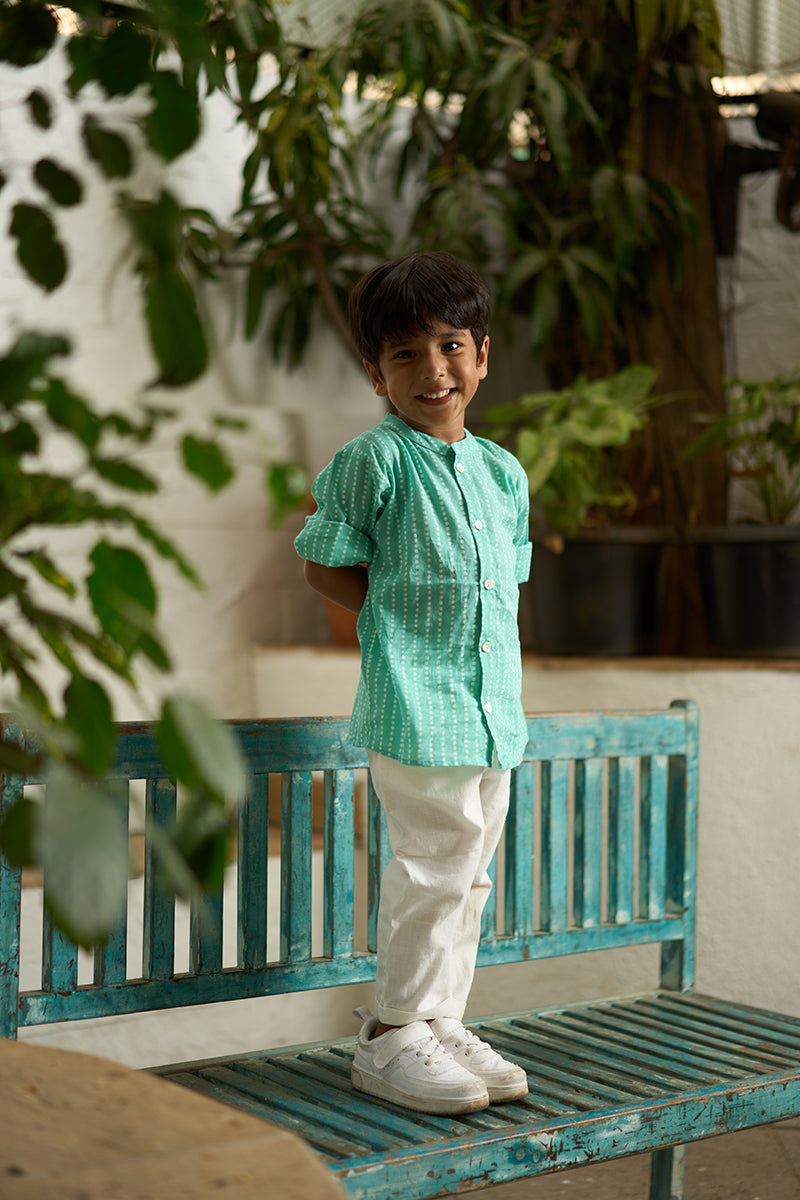 Little-boy-in-Lovetheworldtoday's-classic-Barefoot-Boy-mandarin-collar-hand-block-printed-cotton-unisex-full-sleeve-summer-shirt-in-blue-with-white-polka-dots-for-boys-and-girls