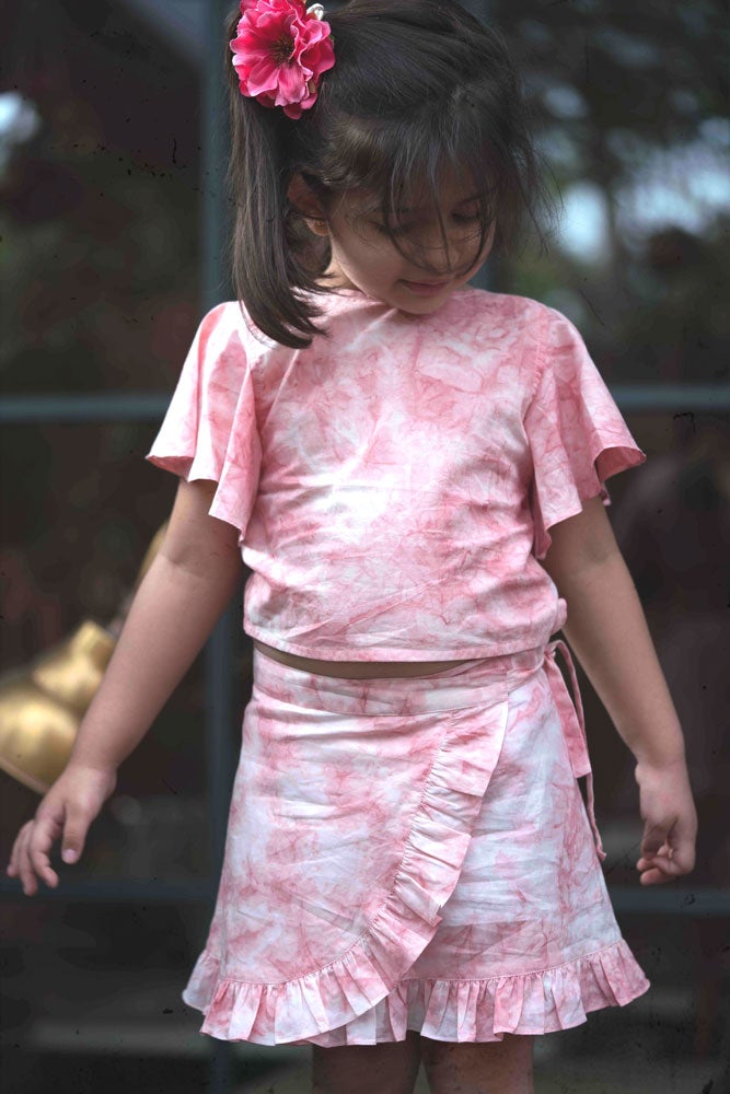Little girl in pink skirt and top set made with organic cotton and natural dye. 