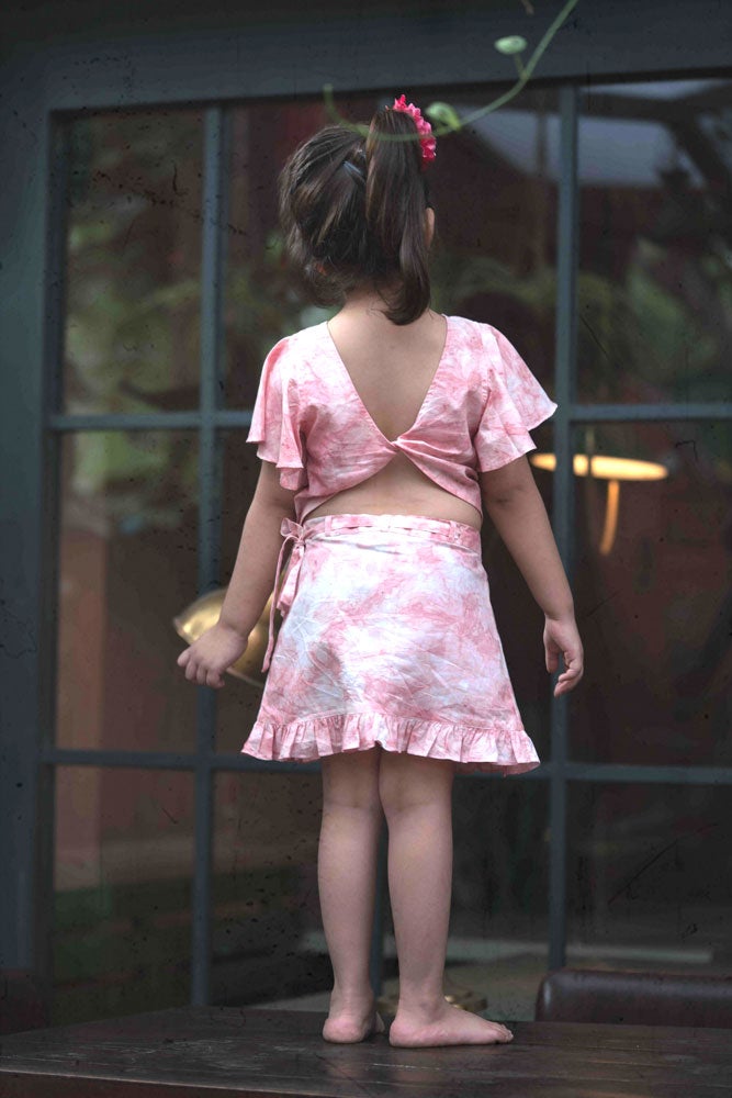 Little girl in pink skirt and top set made with organic cotton and natural dye. 