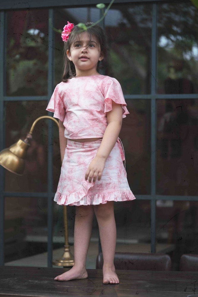 Little girl in pink skirt and top set made with organic cotton and natural dye. 
