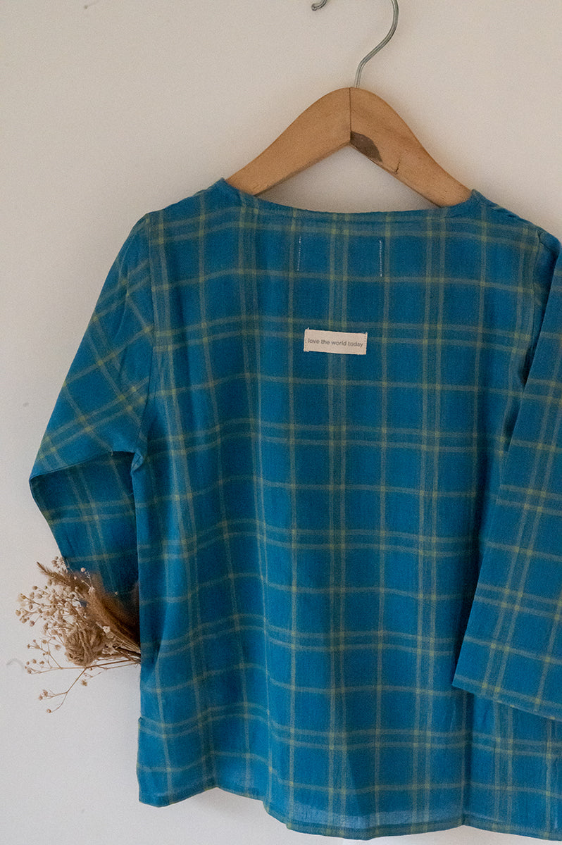 Kids unisex Kurta Pajama set wiith Navy Blue Checks Kurta and White Pajamas perfect for summers. Kurta made with soft breathable handwoven cotton and pajamas made in GOTS certified organic cotton. 