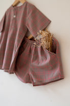Summer night suit for boys and girls in handwoven cotton in warm sand and pink checks. Perfect co-ord set for summer. Half sleeve kurta in soft handwoven cotton with elasticated shorts. Kurtas and Pajamas,  both have pockets.