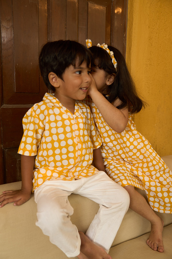 cute-little-siblings-sharing-a-secret-dressed-in-lovetheworldtodays-kids-half-sleeve-casual-holiday-shirt-with-yellow-polka-handblock-print