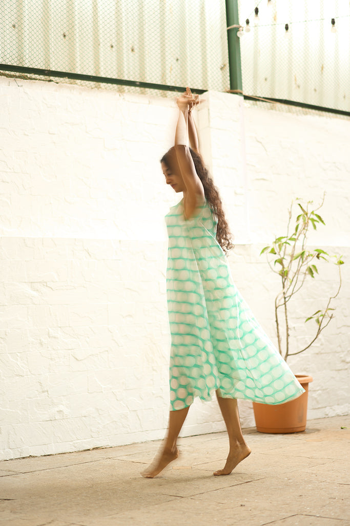 woman-twirling-and-dancing-in-lovetheworldtodays-womens-sleeveless-summer-flared-dress-in-blue-polka-handblock-print-purecotton-made-in-jaipur