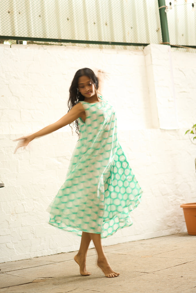 woman-twirling-and-dancing-in-lovetheworldtodays-womens-sleeveless-summer-flared-dress-in-blue-polka-handblock-print-purecotton-made-in-jaipur 